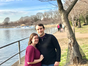 a young couple stands in the tidal basin in Washington dc