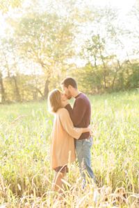 A September backyard anniversary session in Woodsboro MD. A couple shares an deep kiss under the glowing sun