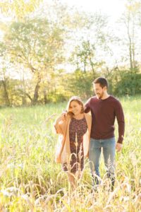 A September backyard anniversary session in Woodsboro MD. A couple laughs and walks through tall grass under glowy sun