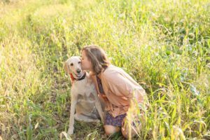 A September backyard anniversary session in Woodsboro MD. A girl kisses her dog