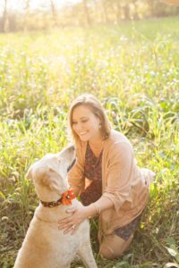 A September backyard anniversary session in Woodsboro MD. A girl plays with her dog under the glowy sun