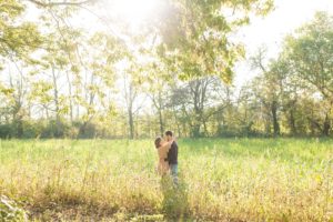 A September backyard anniversary session in Woodsboro MD. A couple stands in a loving embrace under the golden glow of the sun