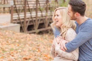 Cozy Autumn Engagement Session at Rockburn Branch Park in Elkridge, MD. A loving couple embraces and laughs together