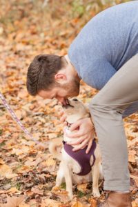 Cozy Autumn Engagement Session at Rockburn Branch Park in Elkridge, MD. A man gets a kiss from his dog