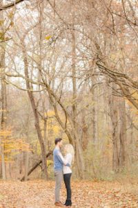 Cozy Autumn Engagement Session at Rockburn Branch Park in Elkridge, MD. A loving couple stands in sweet embrace