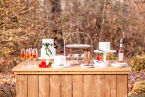 A dessert table with Christmas themed bakes and drinks stand on the grounds of Liriodendron Mansion in Bel Air Maryland for a winter wedding