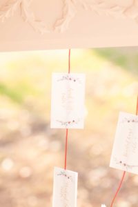A guest card hangs from a styled display created by Atwater Lane at the Liriodendron Mansion in Bel Air Maryland for a Christmas Wedding