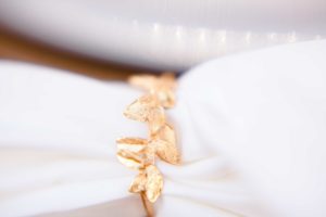 A gold foil napkin holder for a wedding styled shoot styled by Atwater Lane