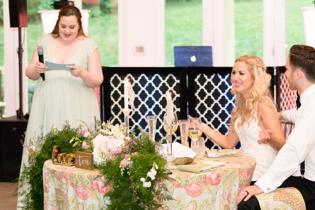 Maid of honor gives her toast and bride reacts for a summer garden wedding reception in Airlie in Warrenton Virginia