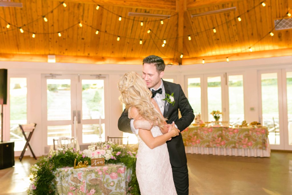 Bride and Grooms first dance underneath the hanging lights for a summer garden wedding reception in Airlie in Warrenton Virginia