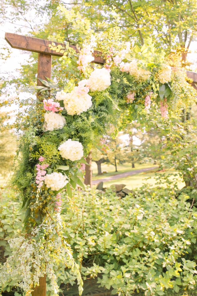 Ceremony Detail of a flowering arch in a summer garden wedding Airlie in Warrenton Virginia