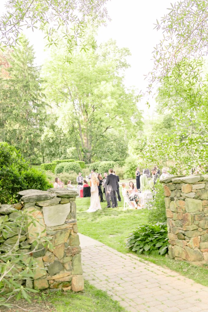 bride and groom join cocktail hour in a summer garden wedding Airlie in Warrenton Virginia