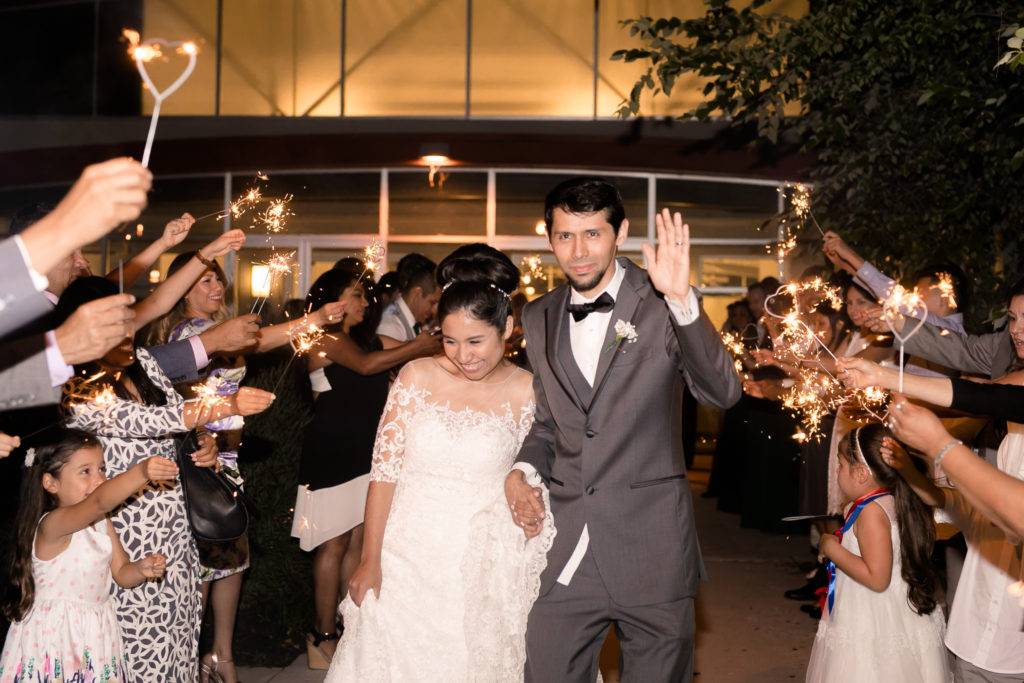 bride and groom exit with sparklers in a summer Frederick Maryland Wedding Reception at Brunswick FireHall