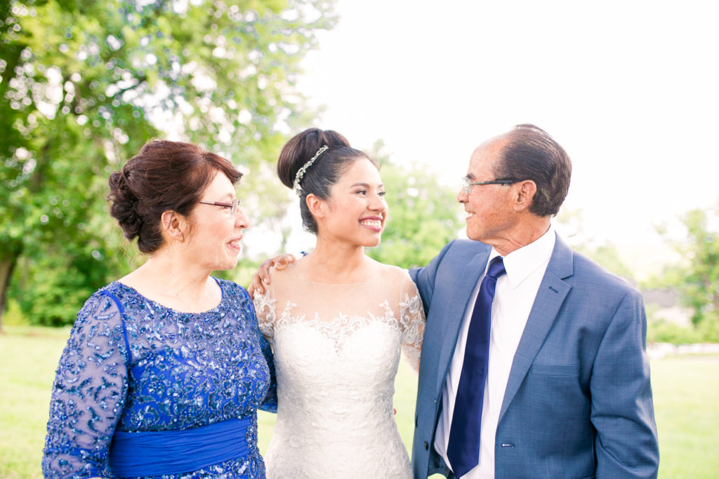 Bride and her parents take portraits for a summer frederick maryland wedding