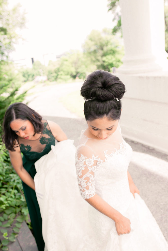 A bridesmaid helps the bride in a summer frederick maryland wedding