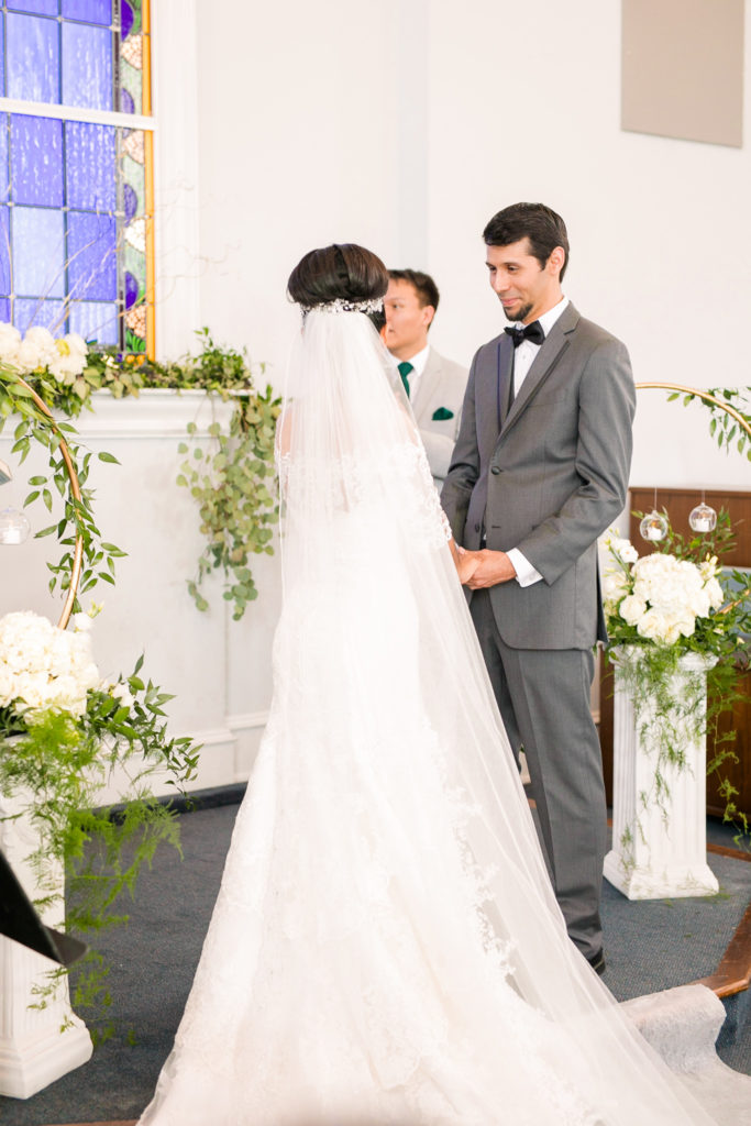 The Bride and Groom stand together for their ceremony in a latino wedding in the summer in frederick maryland wedding at the Seventh Day Adventist Church