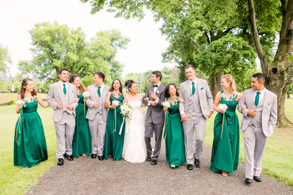 Bride and Groom walk together with Bridal Party in emerald green dresses and ties in a summer Frederick Maryland Wedding at Prospect Hall Mansion 