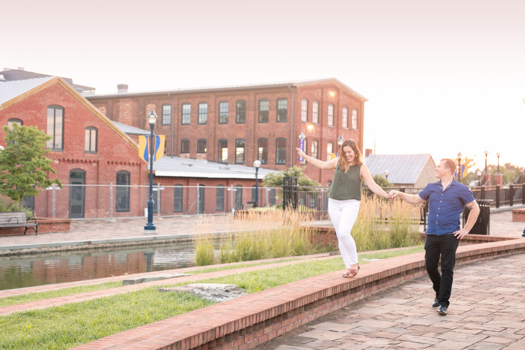 downtown Frederick sunrise summer engagement session with a couple being cute