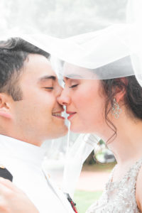 US Naval Wedding in Annapolis Maryland in August for a 1920's themed wedding. Romantic Couple Portraits with Veil outside of Dahlgreen Hall