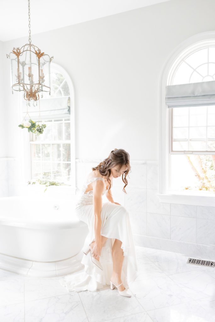 Maryland Wedding Photographer takes a photo of the bride getting ready for her wedding in the bridal suite at Big Cork Vineyards